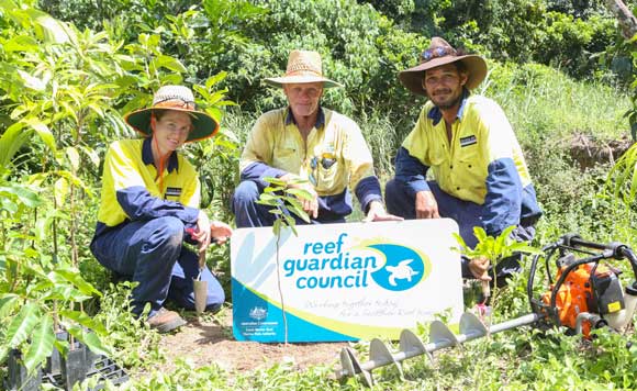 Douglas Shire Council staff holding Reef Guardian Council sign